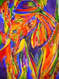 an elephant painted in bright colors with a hat on