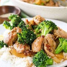 chicken and broccoli stir fry on top of white rice in front of a plate