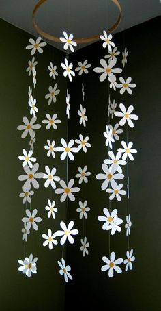 a chandelier with white flowers hanging from the ceiling