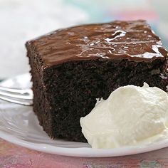 a piece of chocolate cake with ice cream on a plate