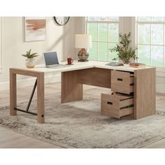 a desk with drawers and a laptop on it