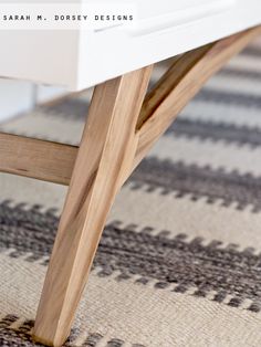 a close up of a wooden table on a rug