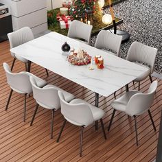 a dining table with white chairs and a christmas tree in the background