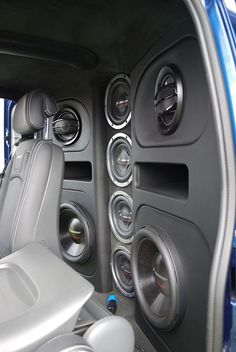 the interior of a vehicle with speakers and steering wheel controls