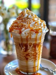 there is a dessert with caramel and whipped cream in the glass on the table