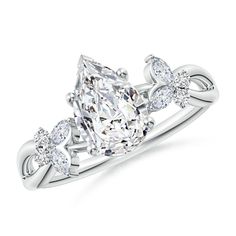 an oval cut diamond ring with three pear shaped diamonds on the shoulders and side stones, set in 18k white gold