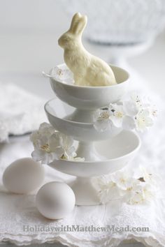 a white plate topped with eggs and a bunny figurine sitting on top of it