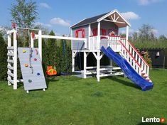 a play set in the grass with a slide and climbing frame on it's side