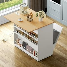 a kitchen island with spice rack and drawers