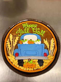 a birthday cake decorated like a truck with the words happy fall written in green on it