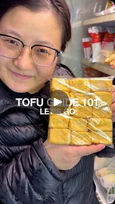 a woman holding up some food in front of her face with the words tofu on it