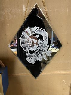 a skull and crossbones glass hanging on a wall