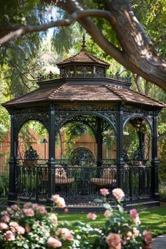 a gazebo surrounded by flowers and trees