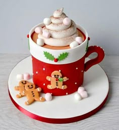 there is a cup cake in the shape of a christmas tree and two gingerbreads