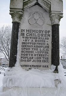 a monument covered in snow with the names of different families on it's sides