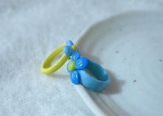 a pair of yellow and blue rings sitting on top of a white plate