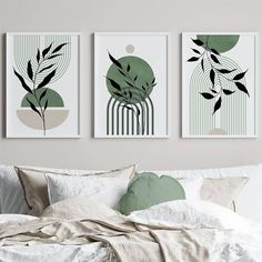 three art prints hanging on the wall above a bed in a room with white sheets and pillows