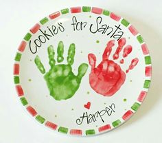 a plate with two handprints on it and the words cookies for santa happen