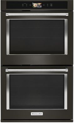 two ovens side by side, one with the door open and one with the light on