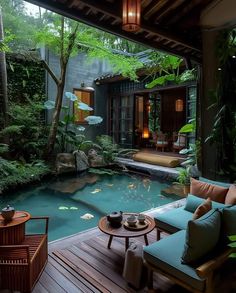 an outdoor living room with a pool and seating area in the center, surrounded by greenery