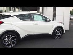 the rear end of a white toyota c - hr