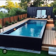 a backyard with a swimming pool and decking