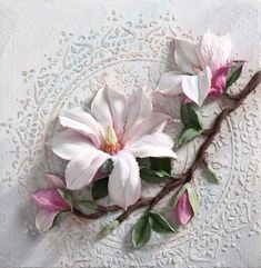 two white and pink flowers with green leaves on a lace doily, next to a twig