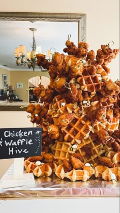 fried chicken and waffles have been stacked on top of each other for display