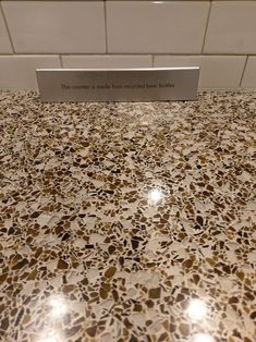 a counter top with a sign that says this counter is made from recycled glass marble