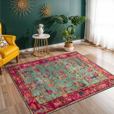 a living room area with green walls and colorful rugs on the hardwood flooring