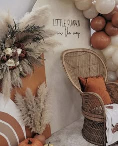 a room filled with lots of balloons and decorations on the wall next to a wicker chair