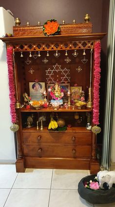 a wooden cabinet with decorations on top of it