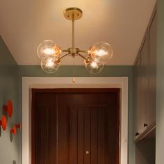 a hallway with a door and two lights on the ceiling, along with an entryway