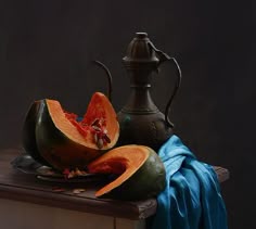 a table topped with sliced up melons and a tea pot on top of it