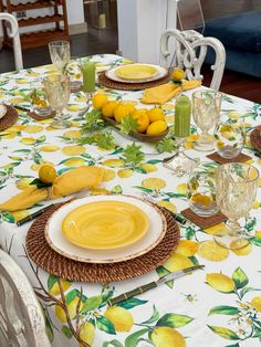 the table is set with lemons and plates