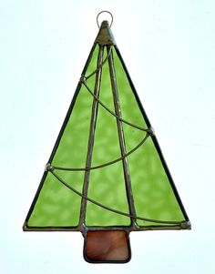 a stained glass christmas tree ornament hanging on a wall