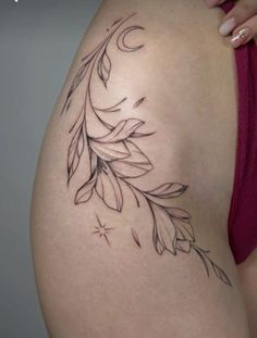 a woman's stomach with leaves and stars tattoo on her back side ribcage