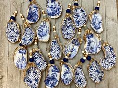 a collection of blue and white porcelain pieces with gold accents on wooden planked floor