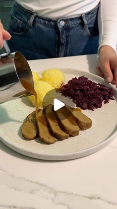 a person is cutting up some food on a plate