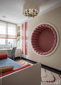 a living room filled with furniture and a round mirror