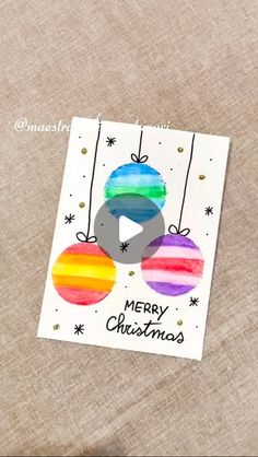 an ornament with christmas balls on it and the words merry christmas written in black