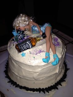 a birthday cake with a doll on top