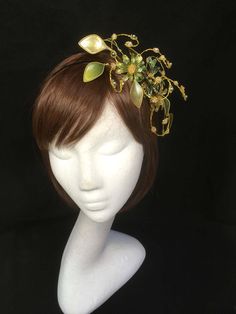 Green floral fascinator vine perfect for the guest or bride who is looking for a beautiful bespoke design. This design is a beautiful selection of glass effect leaves and flowers teamed with crystal swirls and set onto a gold ribbon base tiara band. As with all our designs, this piece can be made exact to the image or in any colour combination to match in with your outfit. If a specific colour is required customers can message over an image of their outfit and accessories, or if time allows cust Green Headband Fascinator For Wedding, Green Pinched Crown Headpiece For Parties, Green Headband Mini Hat For Wedding, Elegant Green Hair Accessories For Wedding, Adjustable Green Costume Hats And Headpieces For Wedding, Green Structured Crown Headpiece For Wedding, Green Wedding Headband Hair Accessory, Green Headband For Wedding, Green Handmade Flowers Wedding Fascinator