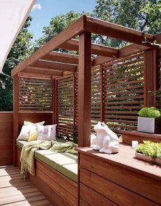 a wooden bed sitting on top of a wooden floor next to a green planter