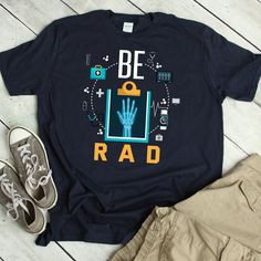 a t - shirt with the words be rad on it next to some shoes