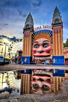 an amusement park with a giant face in the middle