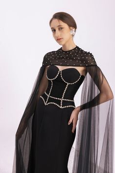 This luxurious set features a unique cape design and a flattering round neckline, made with high-quality twill fabric for a sophisticated look. Perfect for any occasion, it will make you stand out in a sea of ordinary fashion. Chic Fitted Evening Capelet, Black Capelet For Evening Wear, Black Long Sleeve Evening Cape, Elegant Evening Capelet, Fitted Cape With Cape Sleeves For Evening, Elegant Black Capelet With Cape Sleeves, Chic Evening Capelet With Cape Sleeves, Elegant Black Capelet For Party, Black Evening Cape