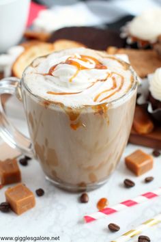 a cup of hot chocolate with whipped cream and caramel drizzle