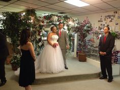 a man and woman standing in front of a wedding ceremony