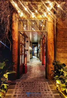 an entrance to a building with lights on it